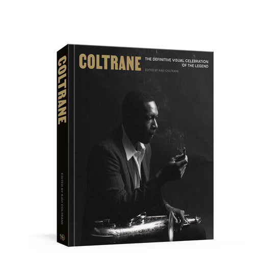 The Definitive Visual Celebration of the Legend: Coltrane, a hardcover book with a black and white cover featuring a portrait of John Coltrane playing a saxophone, shown at a three-quarter angle on a white background.
